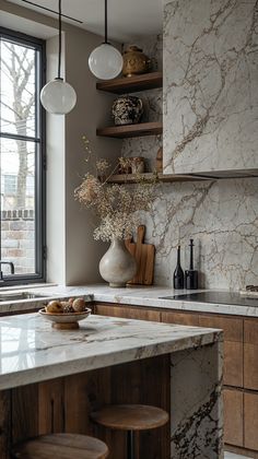 a kitchen with marble counter tops and wooden cabinets