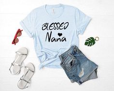 Blessed Nana Shirt, Mothers Day Gift. …………………………………. G A R M E N T • F E A T U R E S : • Unisex Jersey Short Sleeve Tee • Retail fit • Tear away label • Runs true to size • Light fabric (4.2 oz/yd²…More #gift #bride #bridalpartyshirts #tees #bridesmaid #etsy #bridalshower #wedding #cosmeticbag #weddingdayshirts #customshirt #bridal #bacheloretteparty #bachelorettepartyshirts #birthdayparty #mugs #tee #totebag