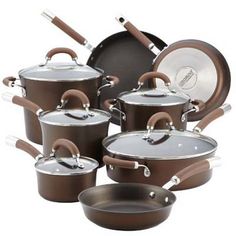 an assortment of pots and pans with wooden handles