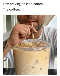 a man holding a straw in front of a cup with coffee on it and the caption reads, i am carving an iced coffee the coffee