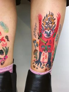 the legs are decorated with colorful tattoos and designs