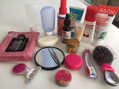 the contents of a woman's personal care kit are displayed on a white table