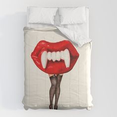 a bed with a painting of a woman's mouth and red lipstick on it