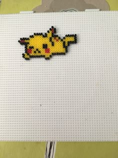 a close up of a piece of art made out of lego blocks with a pikachu on it