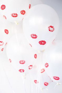 white balloons with red lipstick prints on them