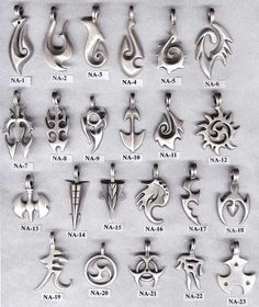 an assortment of silver colored pendants with different designs on them, all in various shapes and sizes