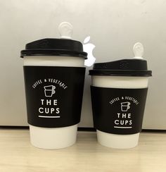 two coffee cups sitting next to each other