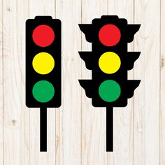 two traffic lights sitting on top of a wooden floor