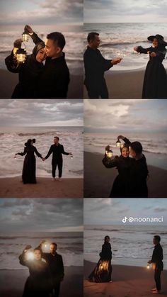 two people standing on top of a beach next to the ocean holding lanterns in their hands