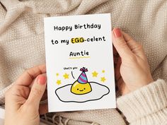 someone holding up a birthday card for their egg - cellent niece to celebrate her special day