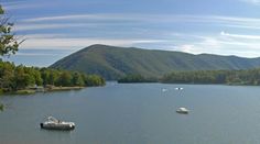 there are many boats that are in the water and one is floating on the lake