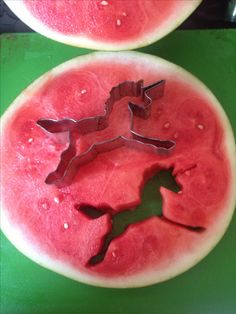 two slices of watermelon with the shape of a horse cut out on them