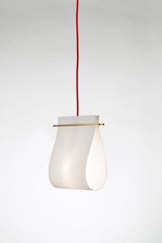 a white light hanging from a red cord