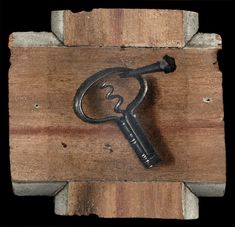 a wooden block with a metal key on it