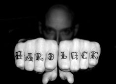 a man holding his hands with the words hard luck written on them in both fingers