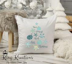 a white pillow sitting on top of a wooden floor next to a christmas tree and other decorations