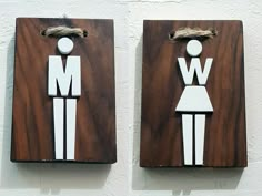 two pieces of wood with the words man and woman on them