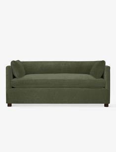 a green couch sitting on top of a white floor