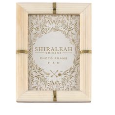 a wooden frame with the words shiralah chicago printed in gold foil on it