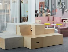 several cardboard boxes stacked on top of each other in a room with tables and chairs