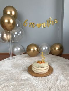 a birthday cake on a table with balloons