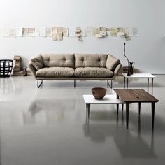 a living room filled with furniture and lots of papers on the wall above it's coffee table