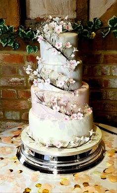 a three tiered wedding cake with flowers on it