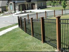 a black iron fence in front of a house