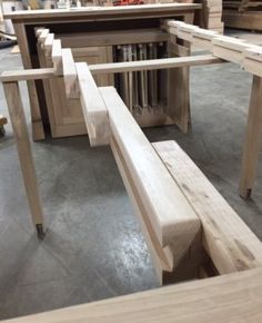 some wooden benches are sitting in the middle of a room with other woodworking tools