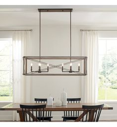 a dining room table with four chairs and a chandelier hanging from the ceiling