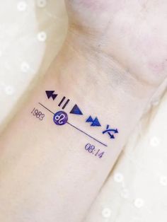 a woman's wrist with three different arrows on it