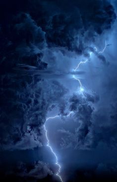 a lightning bolt is seen in the dark clouds