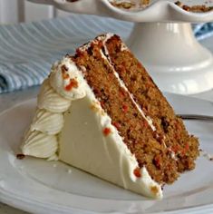 a slice of carrot cake on a white plate