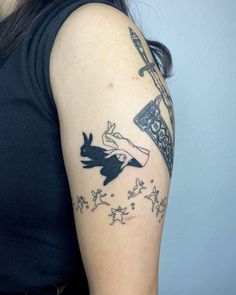 a woman with a black and white tattoo on her arm