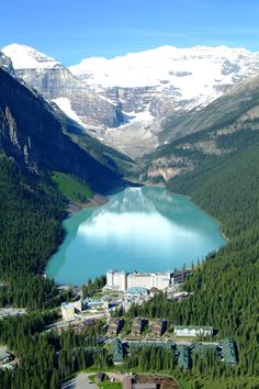 an aerial view of a lake surrounded by mountains