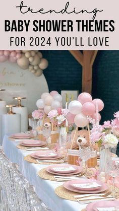 a baby shower party with pink balloons and gold place settings