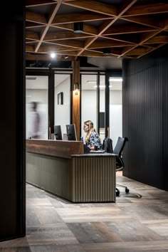 a woman sitting at a desk in an office