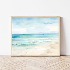 a painting on the wall above a wooden floor in front of a white wall with an ocean view