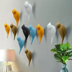 there are many different types of hair on the wall next to a vase and lamp