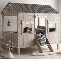 a child's bedroom with a wooden bunk bed and lights on the ceiling, next to a christmas tree