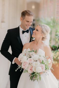 a bride and groom smile at each other