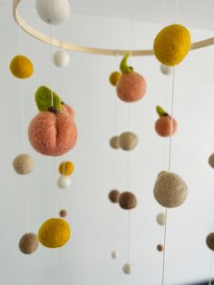 a mobile made out of felt balls hanging from the ceiling