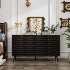 This modern 4-door sideboard offers a stylish and functional storage solution for your home. The spacious countertop is perfect for displaying your favorite decorative pieces or providing additional workspace. We love that the black embossed textured doors give this cabinet a sophisticated and unique look, while the silver hardware adds a touch of elegance. Bonus: This sideboard is both water and scratch-resistant, ensuring it stays looking great for years to come. The adjustable shelves inside Black Buffet Cabinet, Modern Wooden Sideboard, Modern Sideboard Buffet, Black Buffet, Lacquered Sideboard, Entry Room, Dark Modern, Nyc Home, Wooden Bedroom