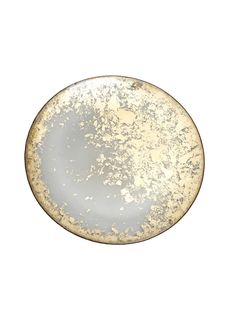 a white and gold plate sitting on top of a table