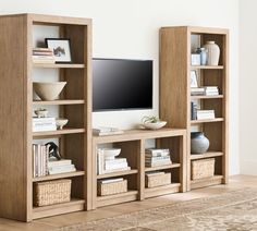 an entertainment center with bookshelves and a flat screen tv