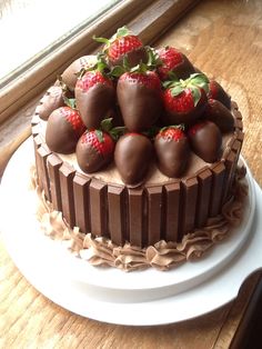 there is a chocolate cake with strawberries on top