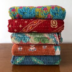 four different types of fabric stacked on top of each other in various colors and patterns