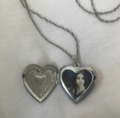 two silver heart shaped lockes on a chain