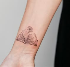 a small book with a flower on the wrist