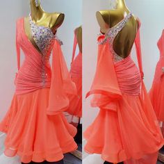 an orange dress is displayed on a mannequin